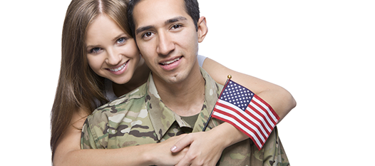 Woman holding american flag hugging servicemember